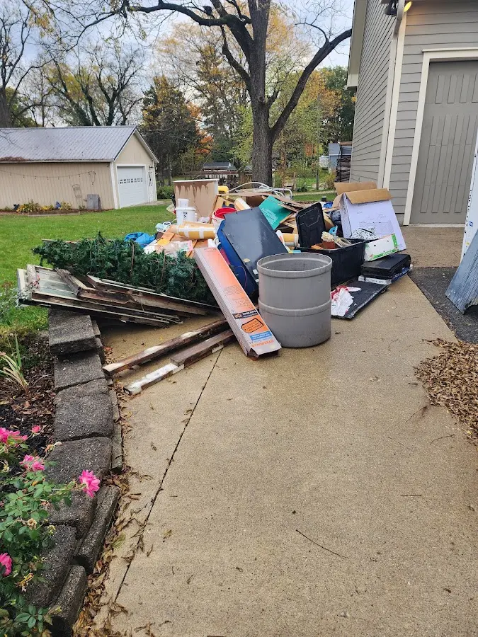 Dumpster being loaded with debris for 10 Yard Dumpster Rental in Highland City